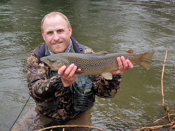 TroutSeason VT Fish & Wildlife photo of Drew Price with an early-season brown trout from a prior year