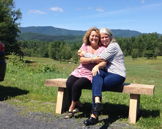Barbra Gulisano and AnneMarie DeFreest on one of the benches created for the Bridge Street beautification project.