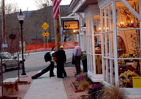 Skiers carry their equipment through Bridge Street to their ski lodge, pausing to chat with Peasant Restaurant owner Chris Alberti. Great food is just one of the many things to enjoy in The Valley as we await snow. Photo: Jeff Knight