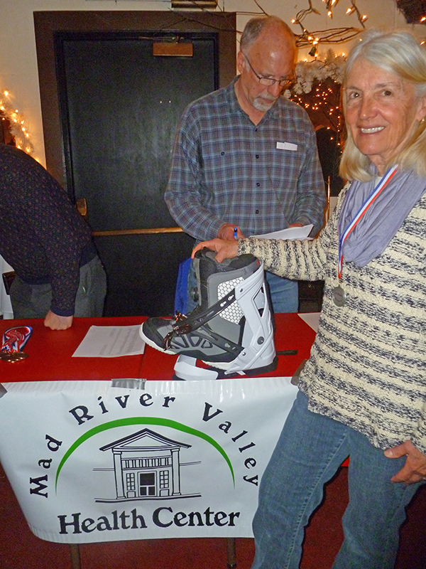 Duncan Brines with Nancy Mercer and a donated boot at the Chez Henri Cup after party.