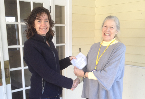 Kate Wanner, Trust for Public Land, accepts a check from Dinsmore Fulton from the Mad River Valley Rotary Club. The local Rotarians contributed $5,000 toward the purchase of the 2,000-plus-acre Dowsville Headwaters conservation project.