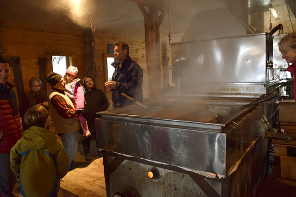 David Hartshorn speaks to a group of maple enthusiasts at the first annual maple Fest held at Hartshorn's Santa Davida farm in Waitsfield. Photo: Jeff Knight