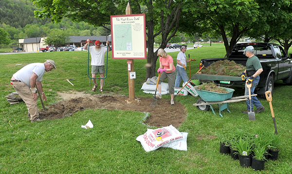 Volunteers work at setting up signs marking  the Mad River Path.