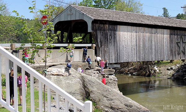 Kids playing on and around the Waitsfield Covered Bridge. Photo: Jeff Knight