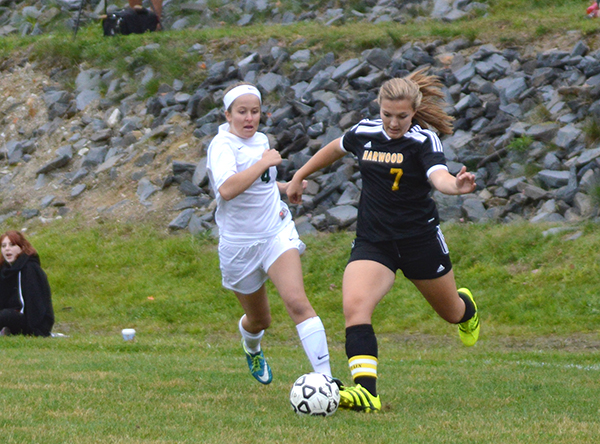 Harwood’s captain Piper Beilke crosses the ball in front of the net in Harwood’s second win of the season against GMVS on October 1. Photo: Chris Keating