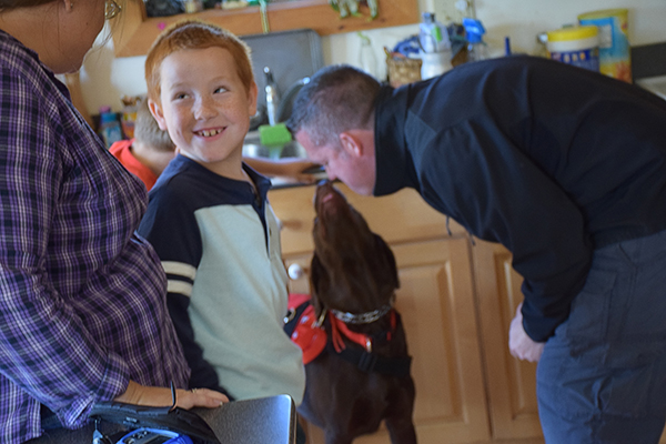 Aiden Heath with his new service dog Angel. Photo: Jeff Knight