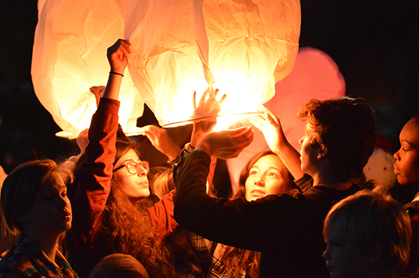 Students send lanterns into the sky to remember friends and loved ones. Photo: Chris Keating