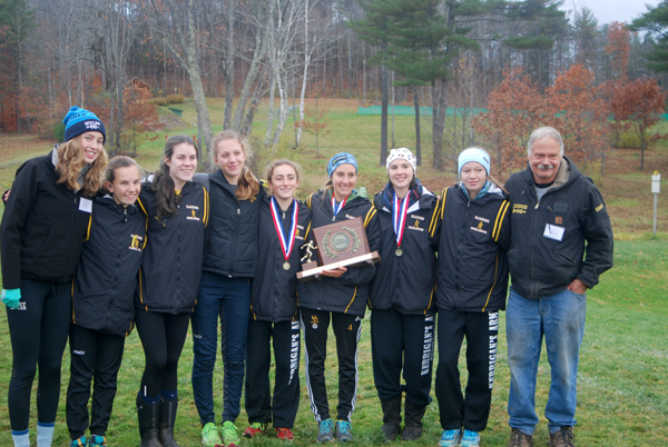 The Harwood girls’ cross-country team took first place for the eighth consecutive year at the Vermont state championships on November 5. Left to right: assistant coach Laurel Whitney (who ran varsity for HUXC in years one through four of the current eight-year winning streak), Julianne Young (freshman), Isabel Jamieson (junior), Phoebe Sweet (junior), Erin Magill (junior), Anneka Williams (senior), Lily Clark (senior), Willa Yonkman (freshman) and coach Kerrigan. Photo: Laura Caffry