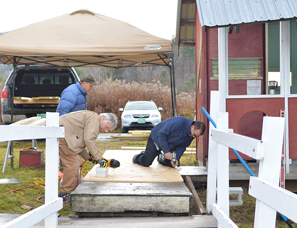 Troy Kingsbury, right, and Brad Cook, foreground, install the first part of the handicap-accessible ramp at Skatium in Waitsfield. Photo: Chris Keating