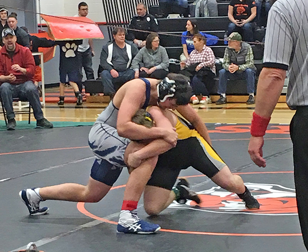 A student from Fair Haven High School, in blue and silver singlet, and Alick Lord, of Harwood Union, in black and gold singlet. 