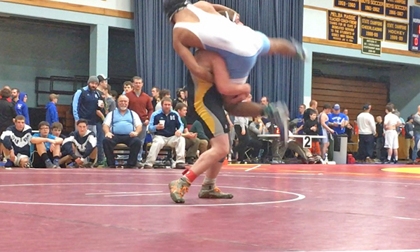 Harwood sophomore Ethan Howes lifts a Middlebury wrestler on Friday, January 13. Howes won the match. Photo: Morgan Howes