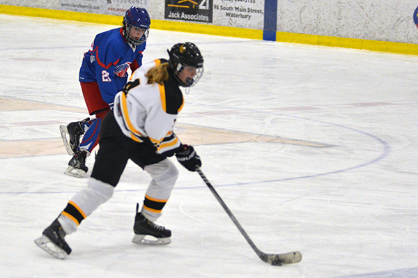 April Tousignant skates the puck over the blue line in the January 25 game against Hartford. Tousignant scored both Harwood goals. Photo: Chris Keating