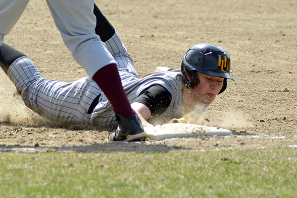 Harwood right fielder, Bobby Kelly, dives back to first base in Harwood's 17-0 win over Northfield April 27. Photo: Chris Keating