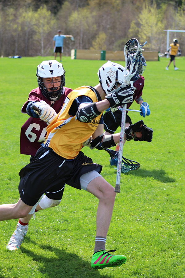 Harwood/Mad River Valley player Charlie Reilly outruns a defender. Photo: Maureen McCracken