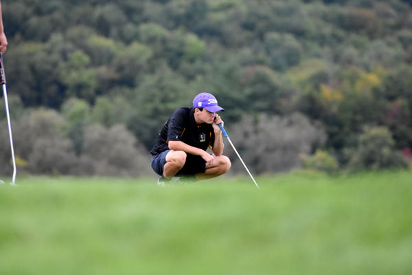 Aidan Melville lines up a putt.