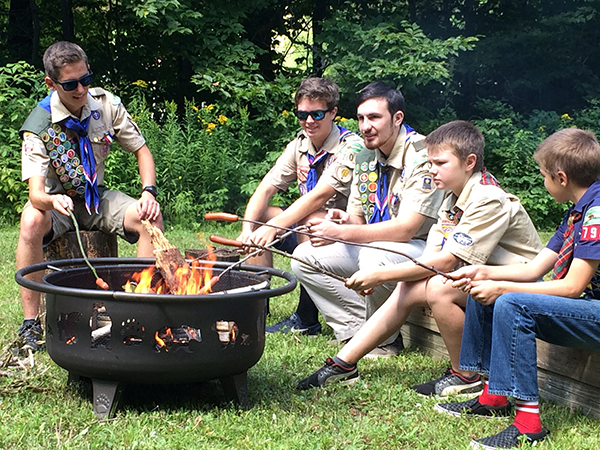Scouts roast hot dogs. (L-R): Boy Scouts Walker Caffry Randall, Tyler Skroski and Seth Davidson and Cub Scouts Owen von Recklinghausen and Christopher Cummiskey