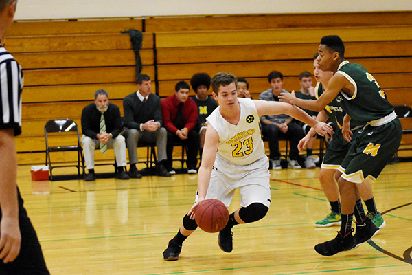 Highlander Max Hill maneuvers around Montpelier's Danny Bruce on Monday, December 18. Hill tallied four points in Harwood's 32-59 loss. Photo: Christopher Keating