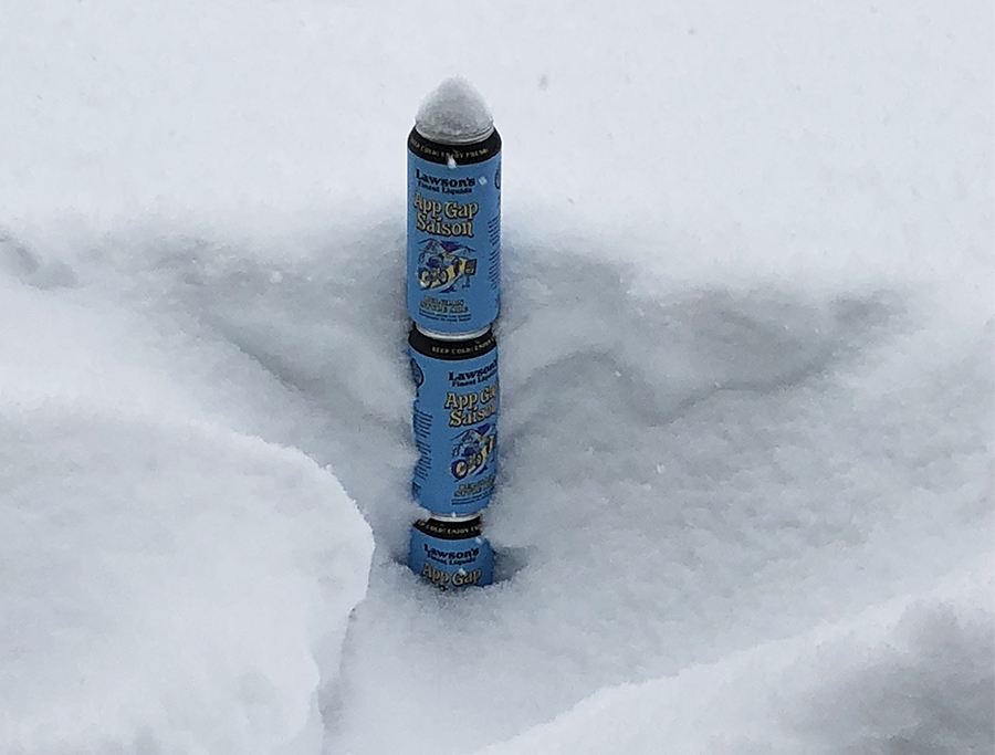 Measuring the snow depth with cans of Lawson's Finest.