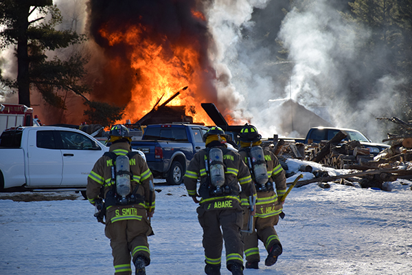 Flames billow from Tiger's Auto Repair as firefighters fight the blaze. Photo: Jeff Knight