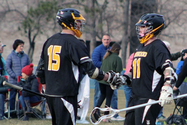 Harwood lacrosse team members Jake Wells and Oli Hammond congratulate each other.