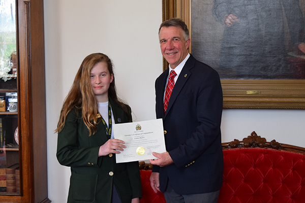 Lindsey Bigelow receives her award from Governor Phil Scott following the end of her six-week session on May 18.