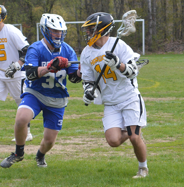 Photo: Katie Martin. Charlotte Cook tries to outmaneuver a Vergennes player in a May 21 game at home