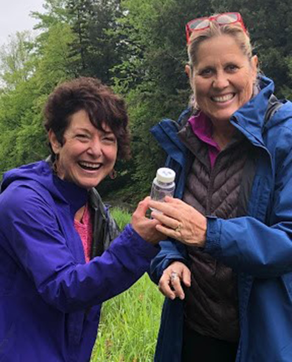 Mad River Watch coordinator Paula Baldwin helps train new volunteer Ruth Lacey in careful sample collection. Photo: Suze Edwards