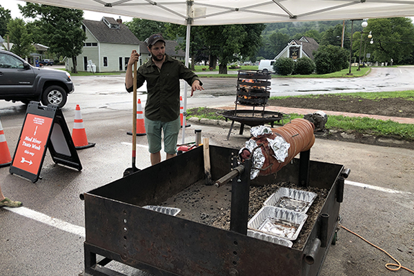 Photo: Robin Morris. Bill Cavanaugh spit-roasts a whole pig for this year’s Mad River Taste Week kickoff on August 3