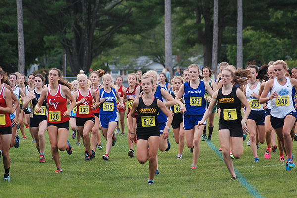 Harwood’s Julianne Young, No. 512, and Ava Thurston, No. 5, lead the pack at the start of the girls’ varsity race. Thurston placed second and Young was 13th. Photo: Laura Caffry.