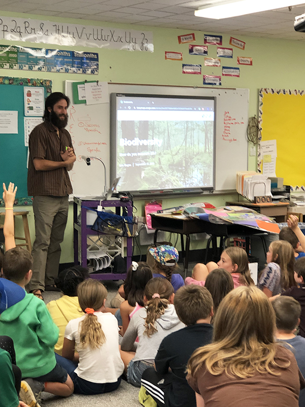 Eric Hagen, UVM grad student and consultant with the Vermont Alliance for Half Earth, speaks to Warren School third- through sixth-graders about biodiversity and the Half Earth Project in preparation for this Thursday’s bioblitz.