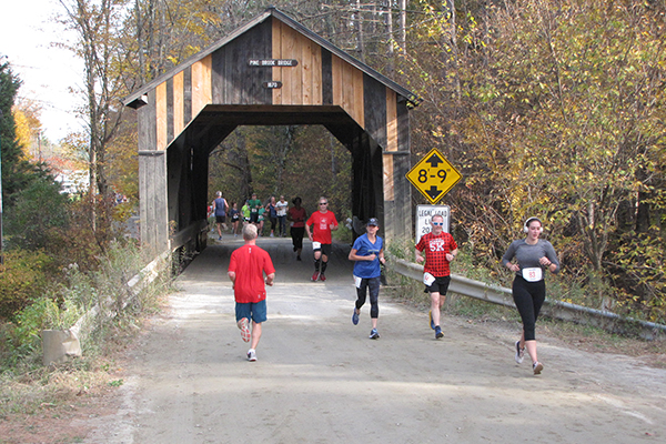 Photo: Michael Cunningham Runners passing through Pine Brook Bridge during Sunday’s Mad Dash