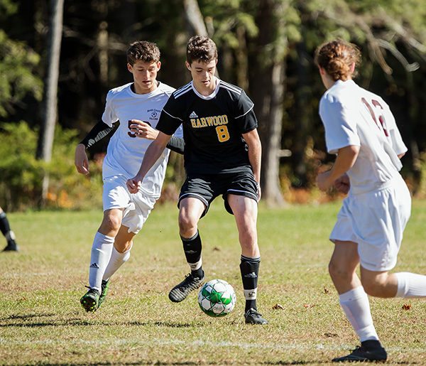 The Highlanders’ Cole Hill maneuvers around North Country defensemen to score Harwood’s first goal in the 2-0 win.