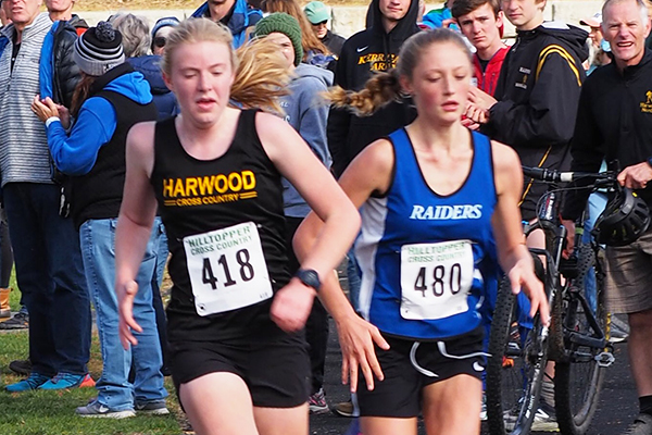 Photo: Ann Zetterstrom. Harwood girls won the NVAC Mountain Division Championship on Saturday, October 19. It was a nail-biter down to the end with a very competitive field of girls from across the entire division. Pictured: Caelyn McDonough races to the finish line to take 10th place overall