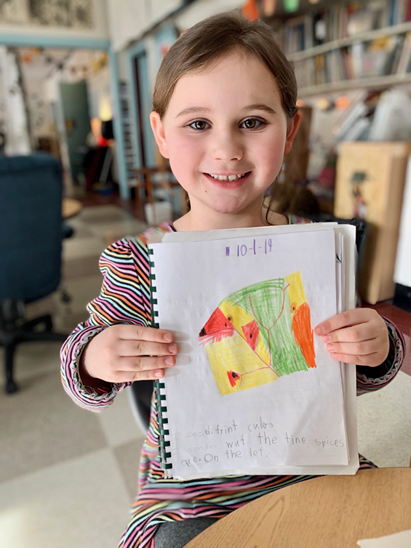 Photo: Hadley Laskowski. Julia Hill proudly displays her close-up drawing of a leaf. “I love the outdoors and animals,” Julia  said. “I love ’em. They’re just really important. Cuz if we didn’t have animals, what would happen?”