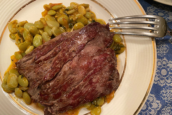 Skirt steak with stewed lima beans