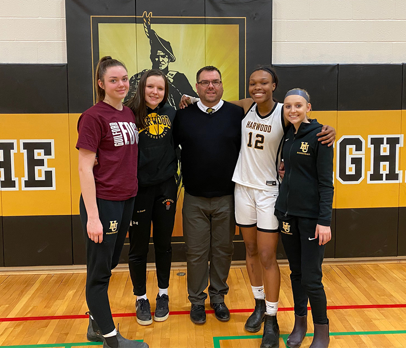 Harwood girls’ hoopsters pose with coach Tom Young on senior night. Left to right: Mia Cooper, Ashlyn Carst, coach Tom Young, Ella Gannon and Kennedy Wimble.