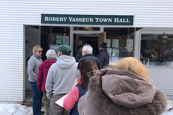 Fayston voters enter the Robert Vasseur Town Hall for Town Meeting. Photo: Annemarie Furey.