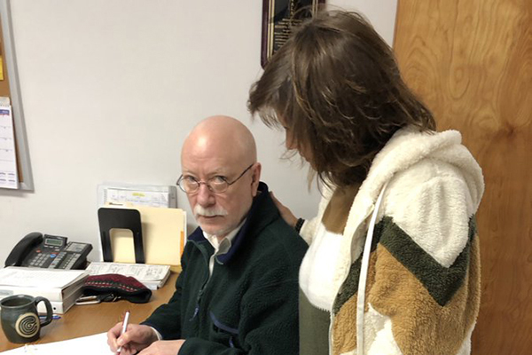 Former Duxbury town clerk Ken Scott, left, and Fayston town clerk Patti Lewis discuss ballot box protocols.