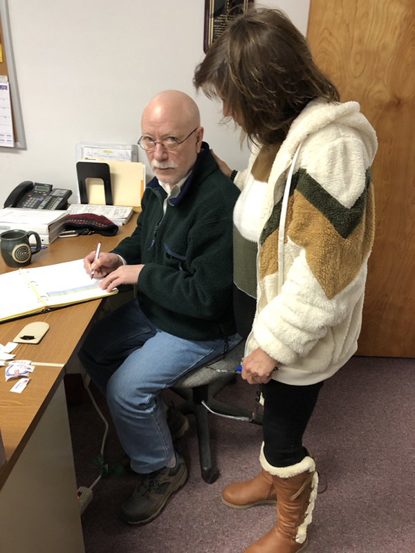 Former Duxbury town clerk Ken Scott, left, and Fayston town clerk Patti Lewis discuss ballot box protocols.