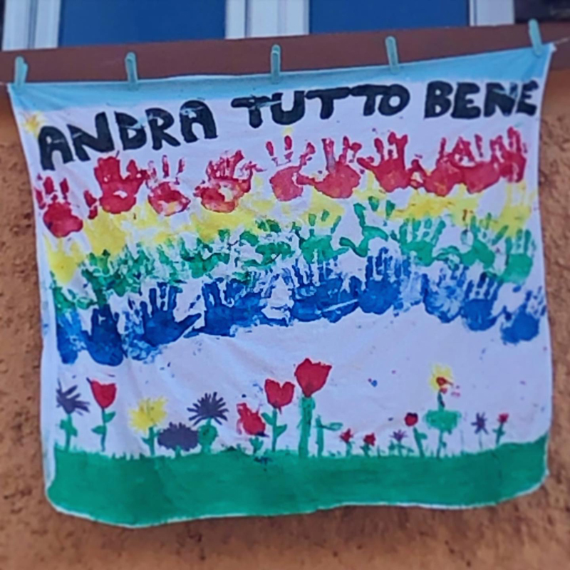 Homemade flags and messages hang from windows as a reminder to keep strong in the face of the coronavirus. Photo: Tina Rocchio