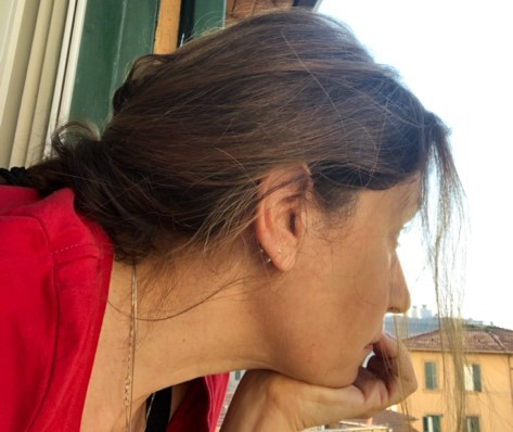 Tina Rocchio looking out her window in Rome, Italy.