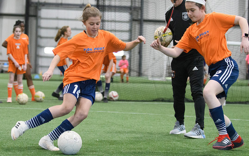 Azra Sakoc and KK Murphy practice their soccer footwork before the pandemic required cancellation of practices.