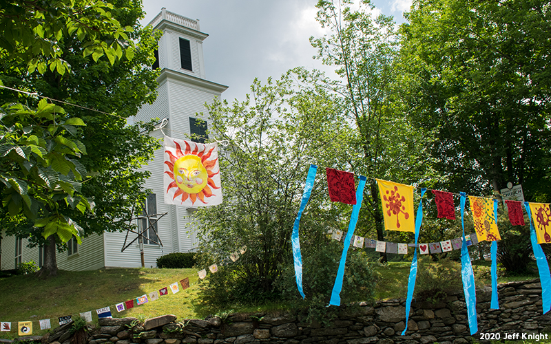 Prayer flags being hung through Warren Village. Photo: Jeff Knight