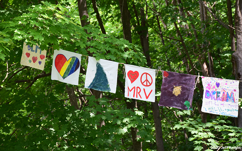 Prayer flags being hung through Warren Village. Photo: Jeff Knight