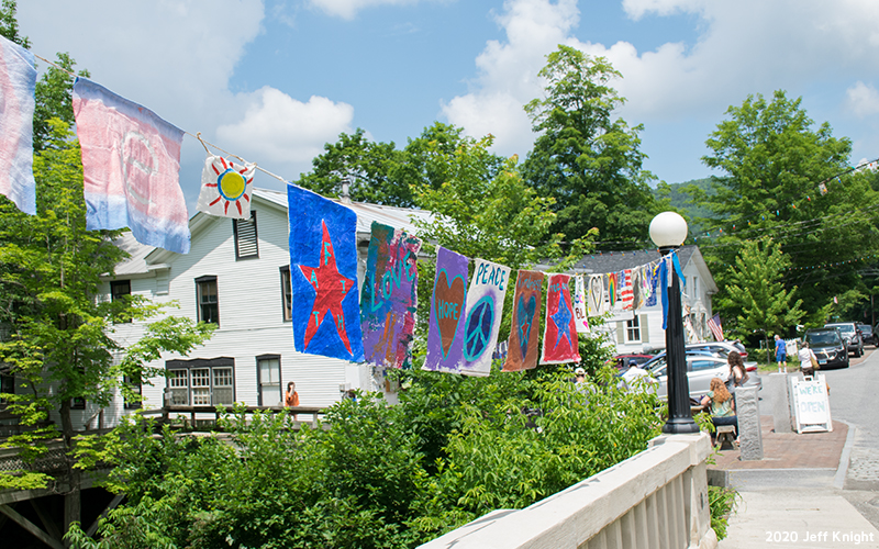 Prayer flags being hung through Warren Village. Photo: Jeff Knight