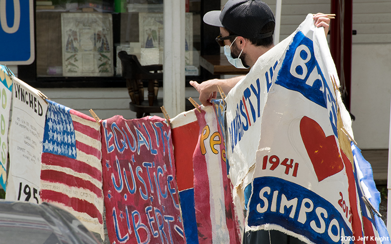 Prayer flags being hung through Warren Village. Photo: Jeff Knight