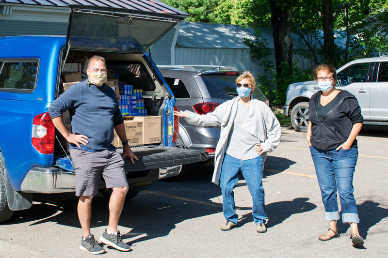 Troy Kingsbury, left, delivers a truckload of disposable menstrual products to the Mad River Valley Food Shelf. Ready to help unload are Lynn Kafer, center, and Jess Tompkins, right.  Photo: Jeff Knight
