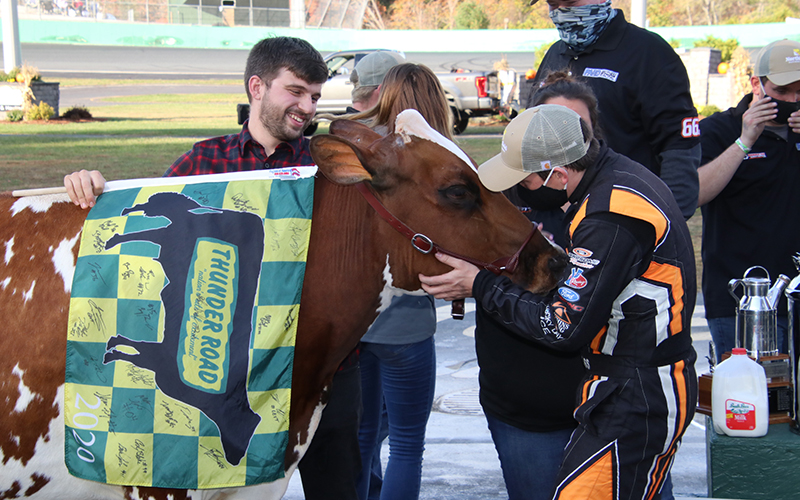 Barre's Jason Corliss (in driver's suit) prepares for a kiss with Miss Vermont Milk Bowl after triumphing in the event for the third time. Alan Ward photo