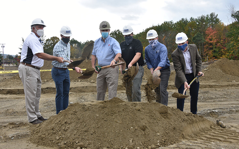 A ceremonial start to Parro's new indoor shooting range, training center and gun shop happens Tuesday while site work rumbles in the background. Left to right: Architect Joe Greene, loan officer Ethan Swain of Granite State Management, Henry Parro, Ethan Parro, John Connor of Connor Contracting and Dave Rubel from Community National Bank in Barre. Photo by Gordon Miller.