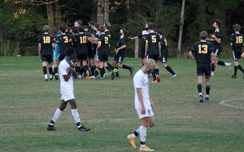 Harwood players celebrate with goalie Jake Collier as the Highlanders beat Montpelier 1-0 on Thursday, October 15. Photo: Jeff Knight